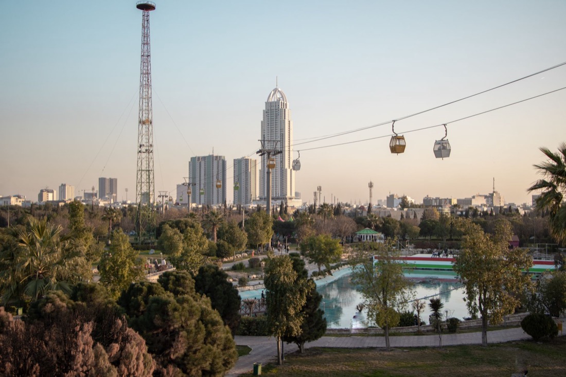 The Erbil skyline seen from a park at sunset, with towers and a cable car in view